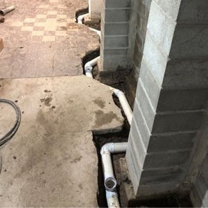 laying pipes through a basement